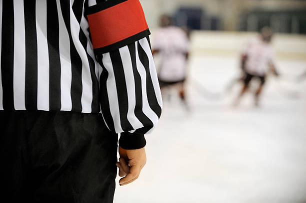 Ice hockey referee in front of players with copy space.Click on an
